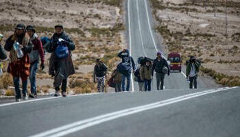 Venezuelan migrants are seen walking along a road linking Bolivia and Chile